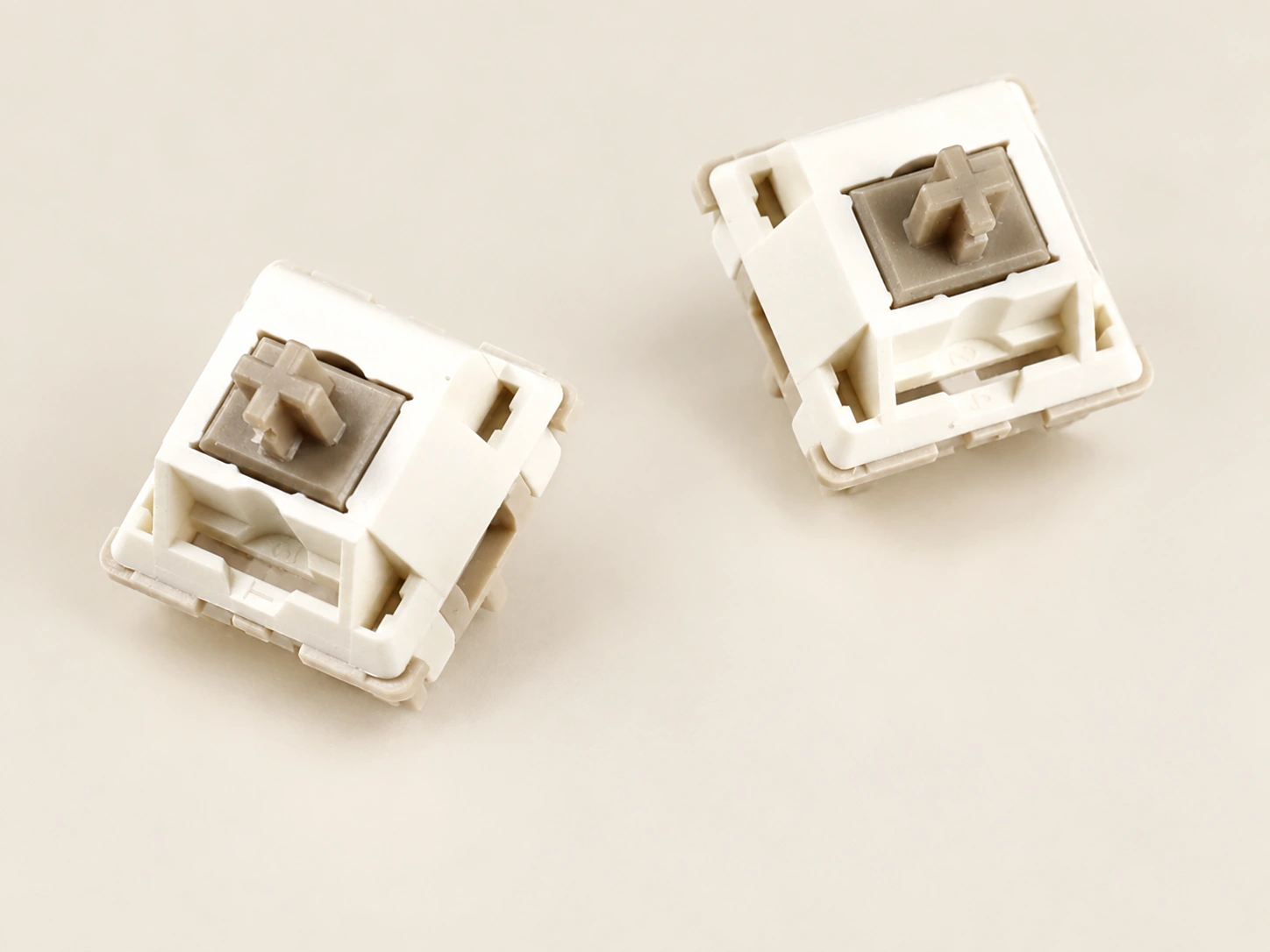 Top views of two cream-colored Xuhua Doll linear switches