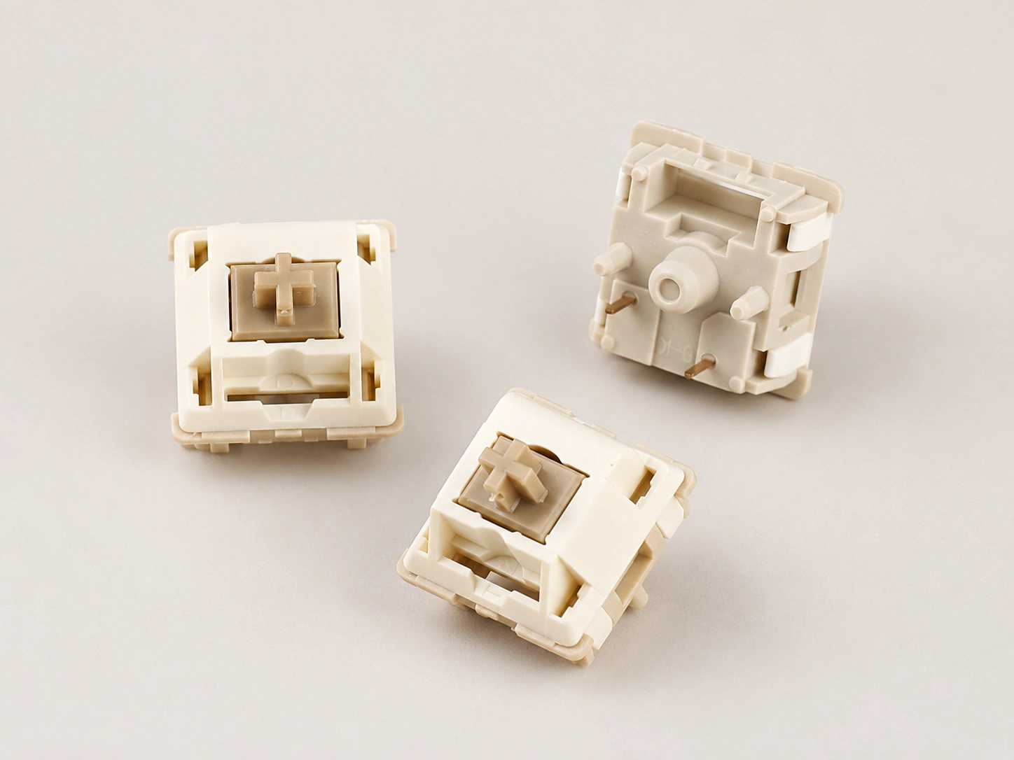 Three Xuhua Doll switches showing top and underside views