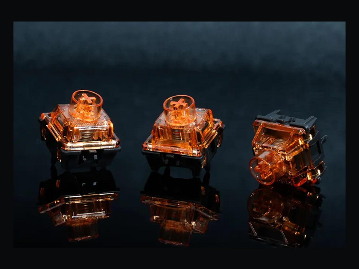 Three Gateron Magnetic Spark Orange switches in a manufacturer product scene