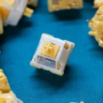 QVQ N2 Milk Dragon V2 switches arranged around a central switch on blue fabric.