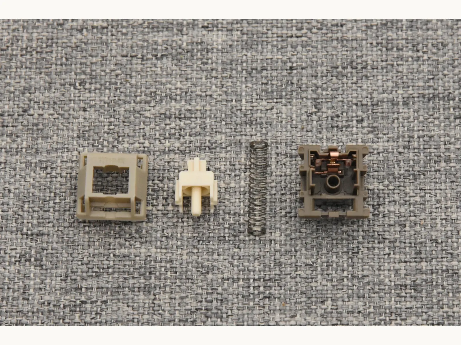 HMX Rain switch disassembled into housing, stem, spring and bottom housing components
