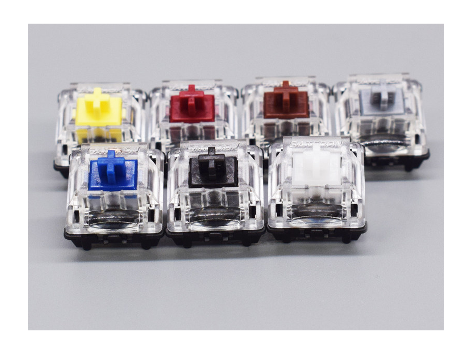 Seven Gateron KS-15 optical switch colors in a supplier photograph; single-color packs sold separately